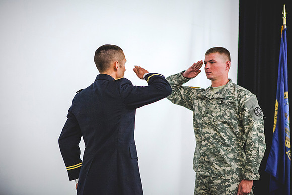 2LT Benjamin Mars gives his first salute to SGT Grisham during the ROTC Commissioning Ceremony.