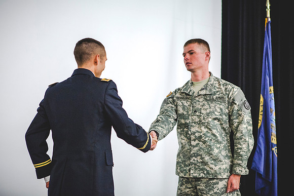 2LT Benjamin Mars gives his first salute to SGT Grisham during the ROTC Commissioning Ceremony.