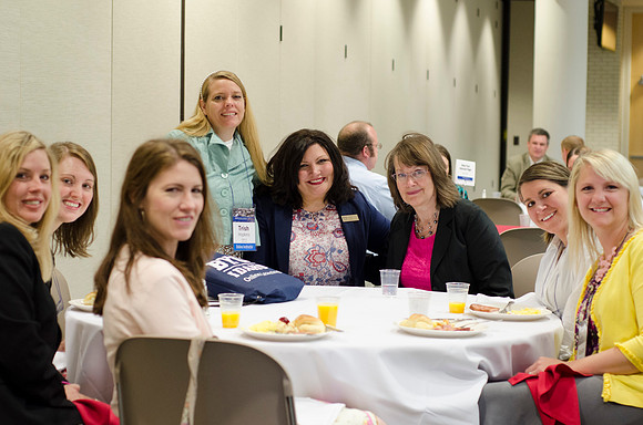Online instructors gather for breakfast and instruction.