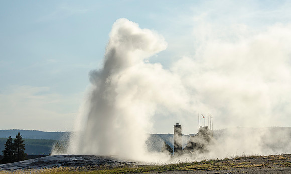 The Old Faithful Inn is framed in by it's namesake geyser in Yellowstone National Park.