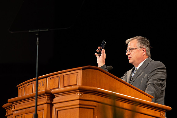 Sam Merrick, Facilities Management Operations Director, speaks during devotional.