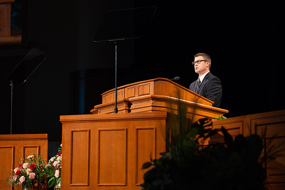 Sam Merrick, Facilities Management Operations Director, speaks during devotional.