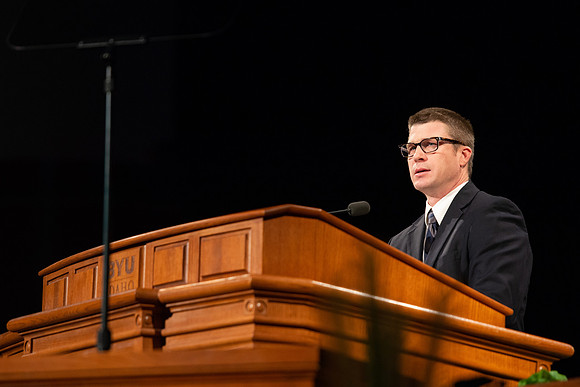 Sam Merrick, Facilities Management Operations Director, speaks during devotional.