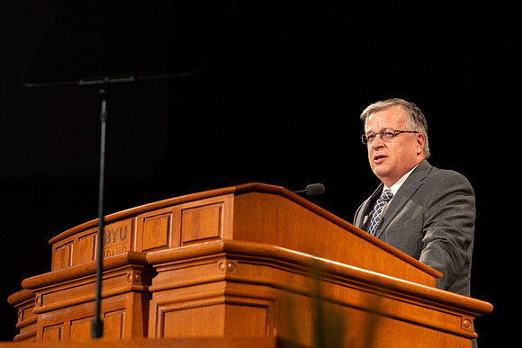 Sam Merrick, Facilities Management Operations Director, speaks during devotional.
