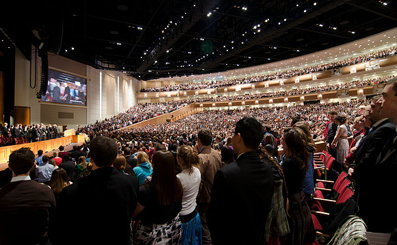 Students stand as Elder Perry enters the auditorium. The BYU-Idaho Center auditorium is filled nearly to capacity for devotional with students eager listen to Elder L Tom Perry, an Apostle to the Lord