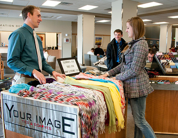 Students from the IBC Business class sell ties and scarfs in the MC Building.