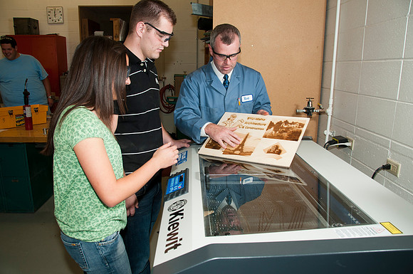 Ron Kinville operates the new Kiewit lazer cutter that was donated to the Architecture and Construction Dept.