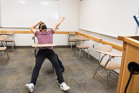 Examples of students staying safe and healthy during the COVID-19 pandemic by social distancing, following pathway arrows, and wearing face masks.