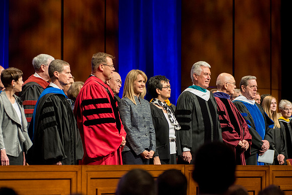 Elder and Sister Bednar, President and Sister Clark, President and Sister Uchtdorf, Elder Oaks, and Elder Holland on the stand during the Processional. Photo by Erik Hill.