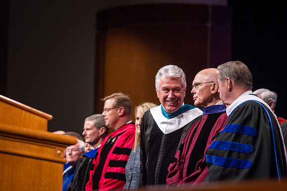 President Dieter F. Uchtdorf, Elder Dallin H. Oaks, and Elder Jeffrey R. Holland, converse before the Inaugurational Ceremony in the BYU-Idaho ICenter. Photo by Tyler Rickenbach