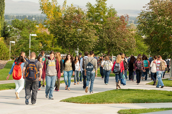 Students walk to and from class in front of the Hinckley Building.