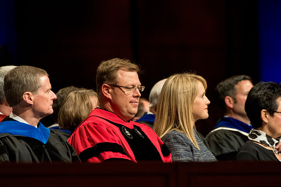Elder Bednar, President and Sister Gilbert on the stand.
