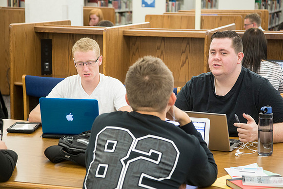 Students work on their homework in the McKay Library on the first day of school.