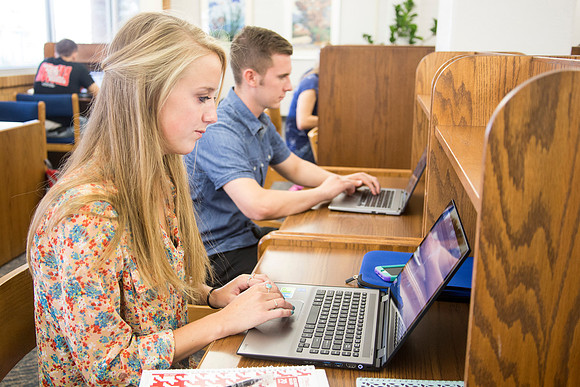Students work on their homework in the McKay Library on the first day of school.