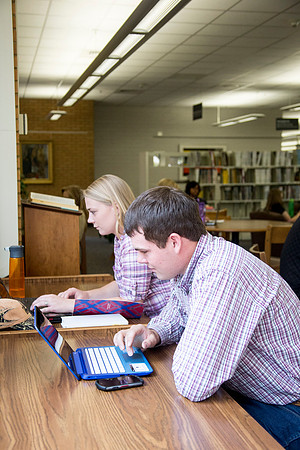 Students work on their homework in the McKay Library on the first day of school.
