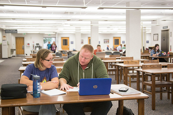 Students work on their homework in the McKay Library on the first day of school.