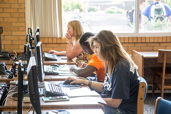 Students work on their homework in the McKay Library on the first day of school.