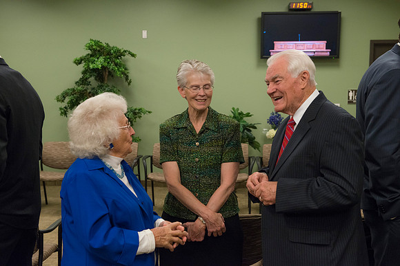 Former President Joe J. Christensen and his wife visit with Betty Oldham.