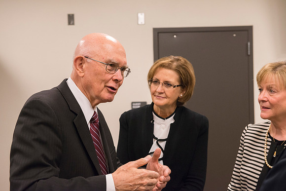Elder Oaks visits with Sister Oscarson and Burton.