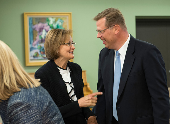 Pres Gilbert visiting with Sister Burton.