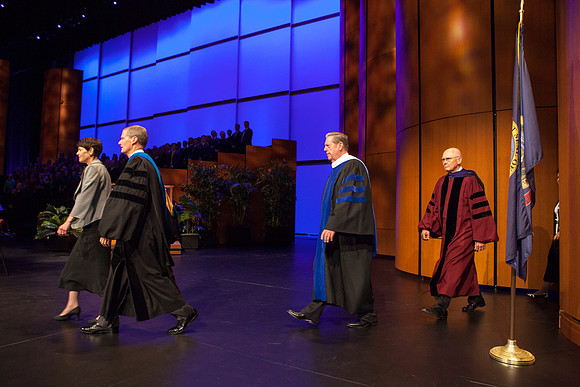 Elder David A. Bednar, Elder Jeffrey R. Holland, Elder Dallin H. Oaks, and President Dieter F. Uchtdorf walk across the ICenter stage as the Inauguration commences.
