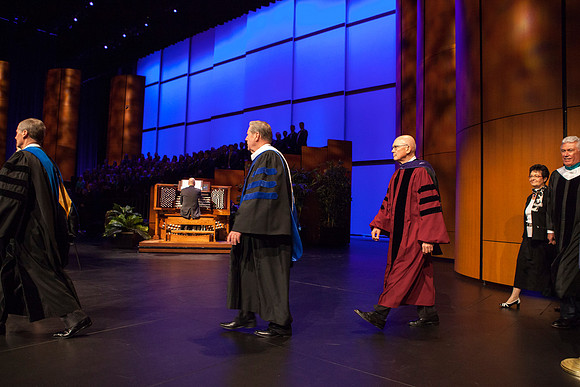 Elder David A. Bednar, Elder Jeffrey R. Holland, Elder Dallin H. Oaks, and President Dieter F. Uchtdorf walk across the ICenter stage as the Inauguration commences.