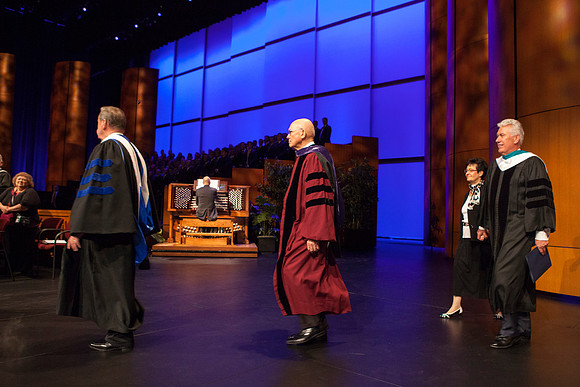Elder David A. Bednar, Elder Jeffrey R. Holland, Elder Dallin H. Oaks, and President Dieter F. Uchtdorf walk across the ICenter stage as the Inauguration commences.
