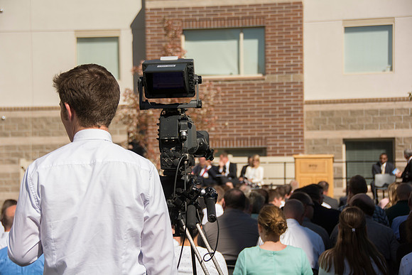 People gather before the dedication of the Center Square Apartments.