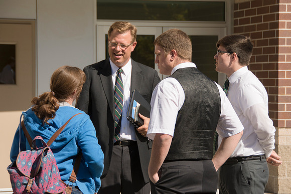 Elder James J. Hamula, of the First Quorum of the Seventy speaks, dedicates the new Center Square apartments.