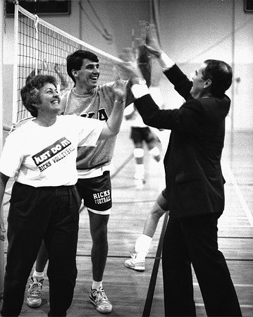 1990, Steven D. Bennion, President of Ricks College gives Volleyball coaches Joanne Reeves and Larry Stocking a High Five.