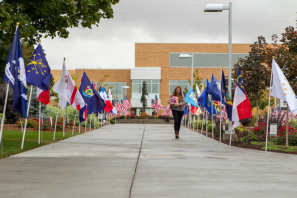 A student walks past the State Flags on Constitution Day.