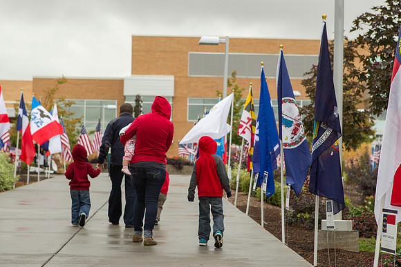 A family admires the many State Flags on display.
