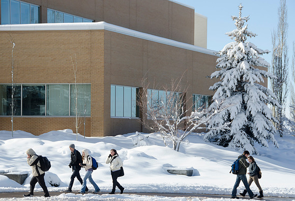 A group of students outside the Spencer W. Kimball Student and Administrative Services Building.