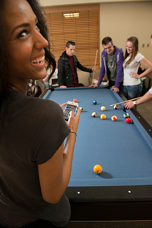 A group of students enjoying a game of pool.