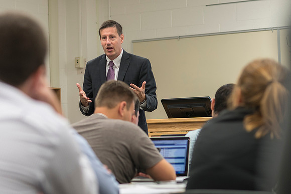Business Management Faculty, Jeff Morrin, teaching an Advanced Financial Management class in Smith 440.