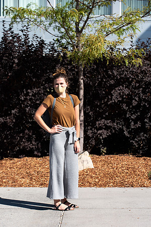 Examples of students staying safe and healthy during the COVID-19 pandemic by social distancing, following pathway arrows, and wearing face masks.