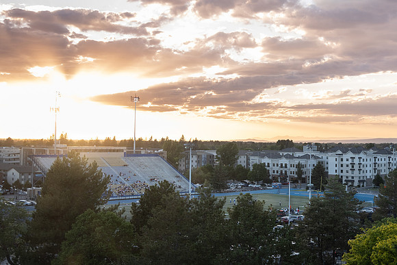 People at the Stadium during sunset for a football game