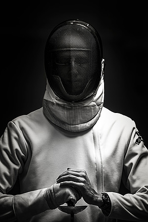 David, an advanced fencer, holds still under the soft light in the Hart Auxiliary Gym.