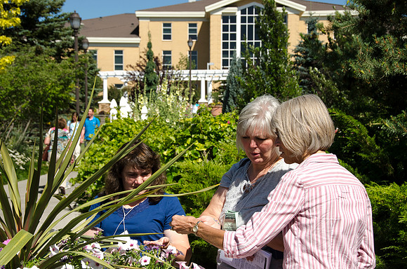 Jilene Burger, Lila Thompson and Ladawn Walker enjoy the flowers in the Thomas E. Ricks Horticulture gardens during Education Week.