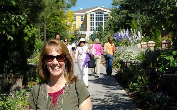 Education Week participant Laurie Stitch enjoying the Thomas E. Ricks Memorial Gardens which are located south of the Gordon B. Hinckley Building.
