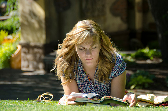 Education Week participant Laura Stoddard studies in the Thomas E. Ricks Memorial Gardens.