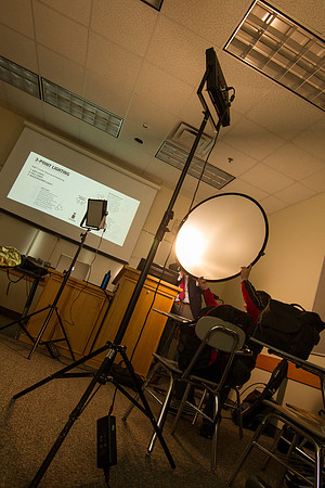 Brother Mawlam gives his students a hands on assignment during class on how to do a "lighted interview."