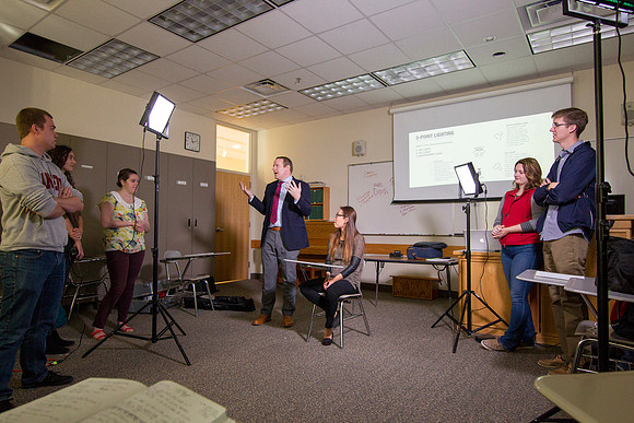 Brother Mawlam gives his students a hands on assignment during class on how to do a "lighted interview."