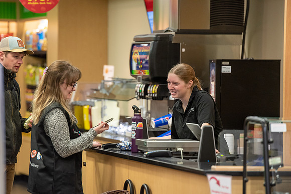 Student employee helping students at the MC Market.