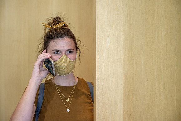Student volunteers show the way to stay safe during this COVID 19 pandemic by social distancing, following pathway arrows and proper wearing of masks .