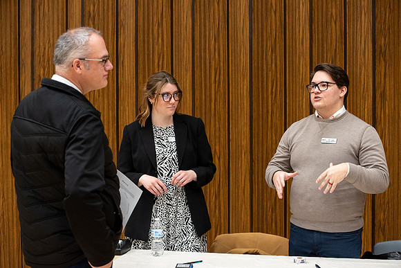 BYU-Idaho Faculty have booths promoting various mental wellness topics. Mix of students and employees mingle among booths.