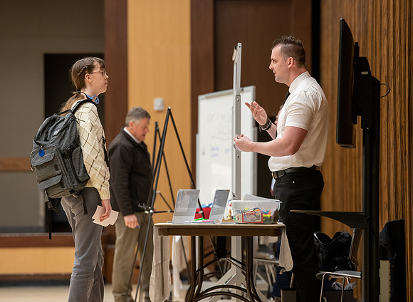 BYU-Idaho Faculty have booths promoting various mental wellness topics. Mix of students and employees mingle among booths.