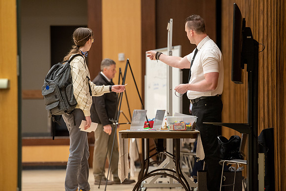 BYU-Idaho Faculty have booths promoting various mental wellness topics. Mix of students and employees mingle among booths.