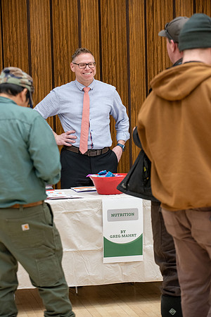 BYU-Idaho Faculty have booths promoting various mental wellness topics. Mix of students and employees mingle among booths.