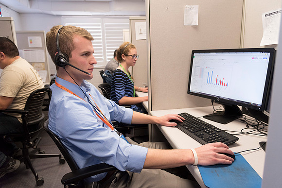Employees work on developing a better curriculum for online students.